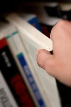 Hand taking book Stock Photos