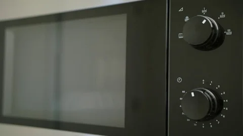 A Hand Taking a Container out of Microwave Oven Stock Footage 82642473