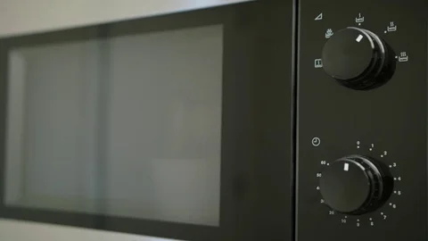 A Hand Taking a Container out of Microwave Oven Stock Footage 82642937