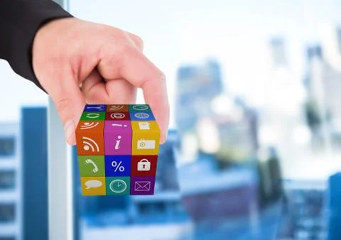 Hand taking cube of application icons. Blurred office background Stock Photos