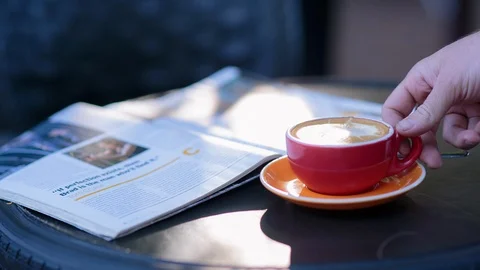 Hand taking a cup of coffee from table Stock Footage 94885126