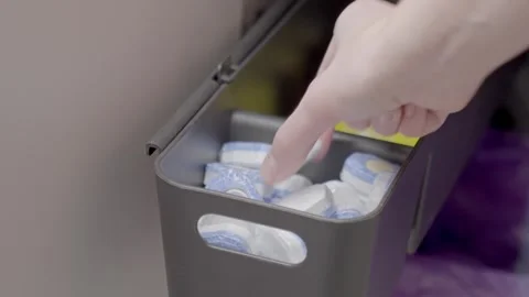 Hand taking dishwasher detergent tablet from storage container Stock Footage 328032956