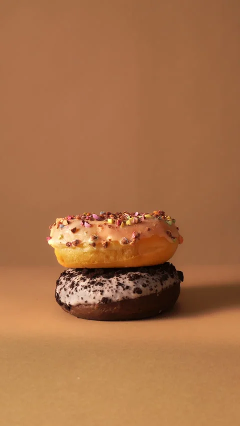 Hand Taking Donuts One by One from Stack in Slow Motion Studio Shot Stock Footage 331232856
