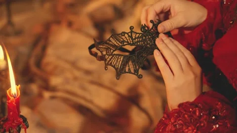 Hand taking dressing black lace carnival mask, mystery woman goes to masquerade Stock Footage 325714450