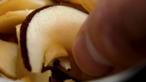 Hand taking dried coconut slice from white bowl. Stock Footage 315113481