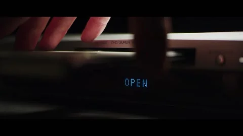 Hand taking DVD out of DVD system in dark room. Stock Footage 142233604