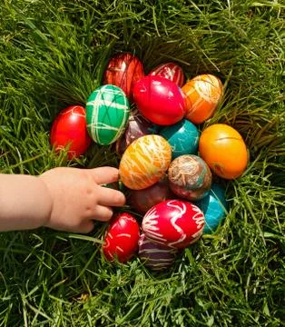 Hand taking Easter egg Stock Photos