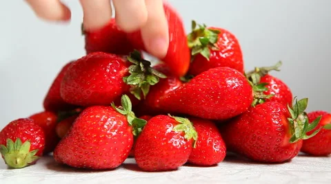 Hand taking few strawberry with copy space on white kitchen Stock Footage 63226659