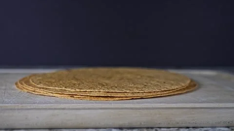 Hand is taking fresh tomatoes flatbread layered on a cutting board 動画素材 305018977