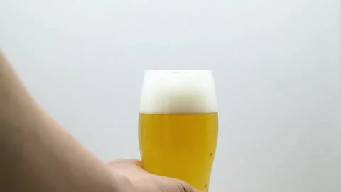 Hand Taking Glass of Beer on White Background Vídeos de archivo 334693674