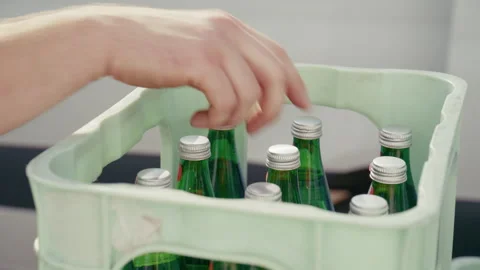 Hand Taking Glass Bottle from Beverage Crate Stock Footage 345892048