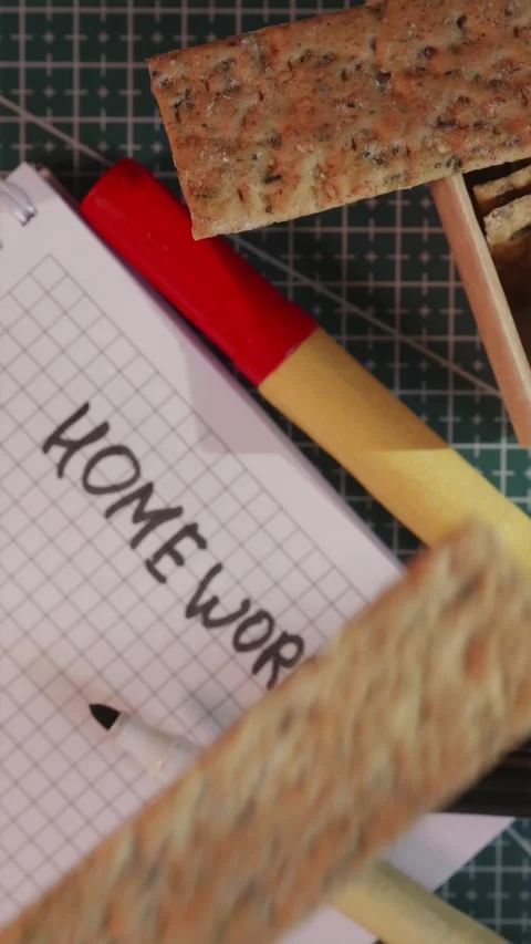 Hand taking healthy crispbread snack during homework study break Stock Footage 341267365