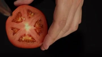 Hand Taking the Inside of a Tomato Out Stock Footage 86131851