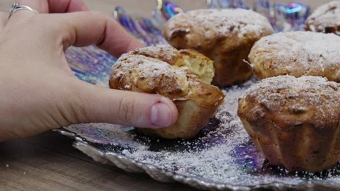 A hand taking a muffin and putting it back bitten. Stock Footage 266427216
