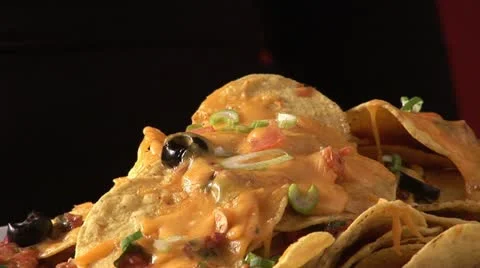 Hand taking nacho with melted cheese from plate 스톡 동영상 24653481