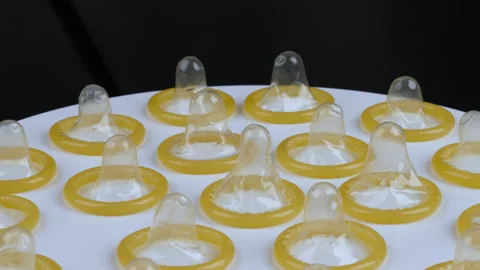 Hand taking one of condom on plate Video stock 166738982