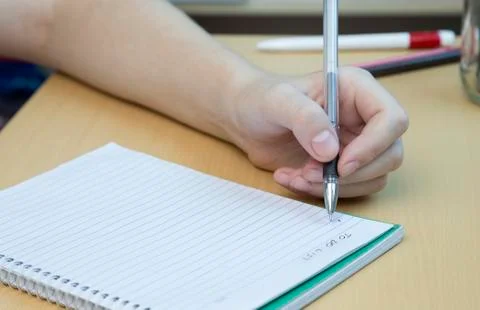 A hand taking or writing notes, close up Foto stock