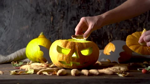 Hand is taking out cookies in the form of a finger from a pumpkin Stock Footage 194406674