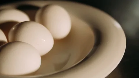 Hand taking out eggs on the plate Stock Footage 125458404