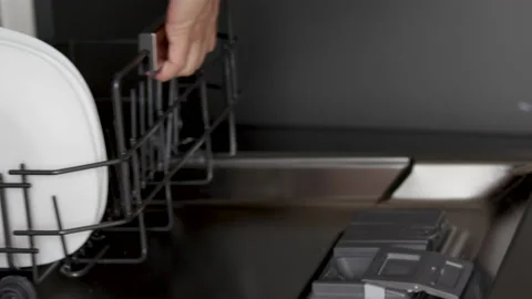 Hand taking off out plates from automatic dishwasher machine,detergent pod Vídeos de archivo 213509967