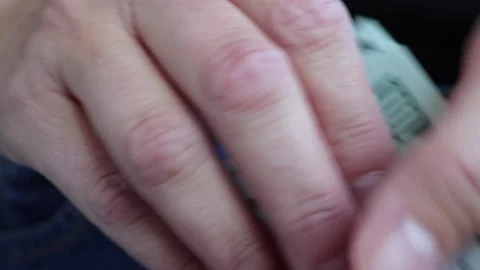 A hand taking out a stack of 100 dollar bills from her pocket Stock Footage 211601219