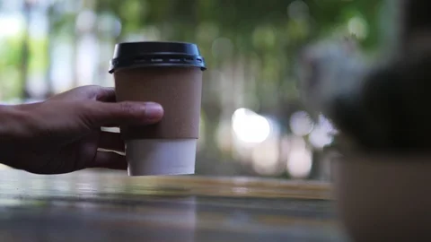 Hand taking paper cup of coffee, hot beverage for breakfast, takeaway service Stock Footage 118847129