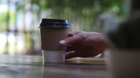 Hand taking paper cup of coffee, hot beverage for breakfast, takeaway service Stock Footage 118847239