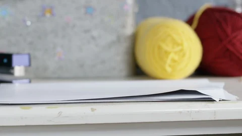 Hand taking paper from table at home Stock Footage 107936461