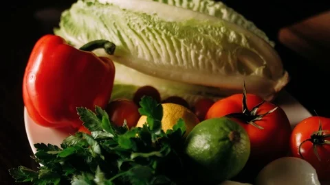 Hand taking a pepper out of the vegetable plate Stock Footage 125458441