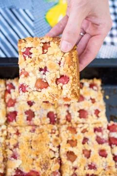 Hand taking a piece of sweet homemade cherry pie with crumble Stock Photos