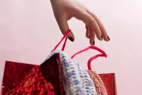 Hand Taking Red Gift Bag Foto stock