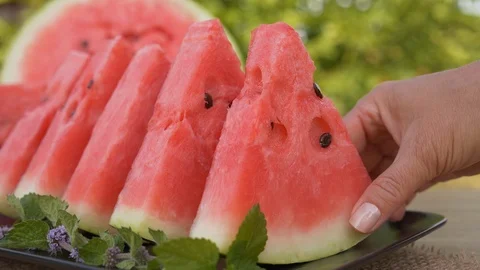 Hand taking red watermelon slice from a plate Stock Footage 126114288