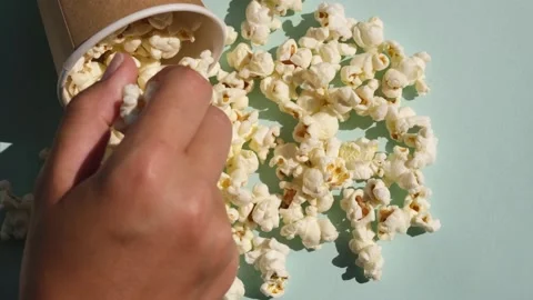 Hand taking salt popcorn from craft paper cup. Stock Footage 220725329