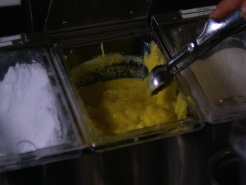 Hand taking a scoop of ice-cream Stock Footage 83185751