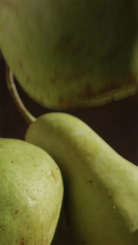 Hand taking single fresh pear covered in water drops close up 스톡 동영상 346903373