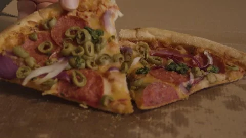 Hand taking slice of delicious pepperoni pizza with olives and onions from .. Stock Footage 337155453