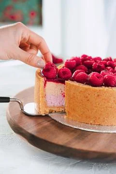 Hand Taking Slice Of Raspberry Cake From Board Stock Photos
