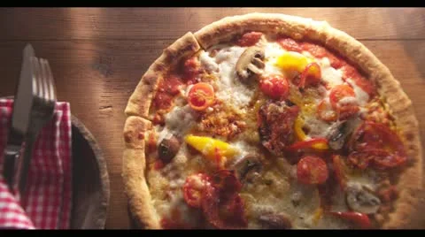 A hand taking a slice of vegetable pizza Stock Footage 24672232