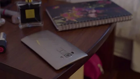 Hand taking a smartphone from a nightstand Video stock 135334332