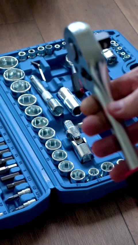 Hand taking a socket wrench from a blue plastic toolbox Stock Footage 346234775