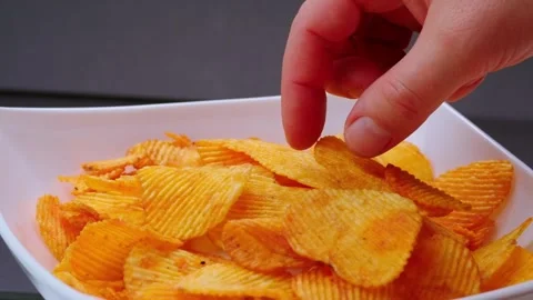 Hand taking some chips Stock Footage 300386052