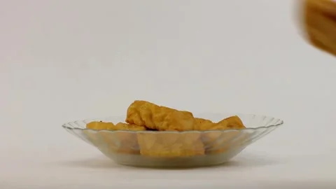Hand taking some fried tofu to eat isolated on white background Stock Footage 315019254