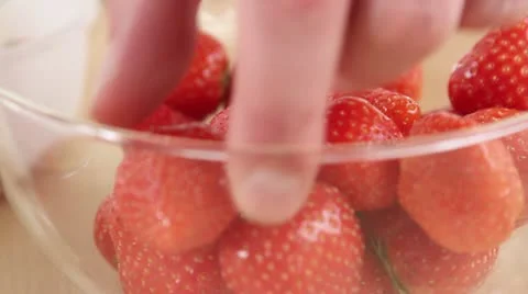A hand taking a strawberry Stock Footage 24650829