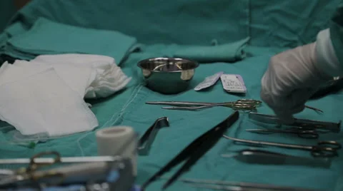 Hand taking surgical instrument Stock Footage 39859309