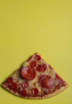 Hand taking a triangular slice of a pepperoni pizza Stock Photos