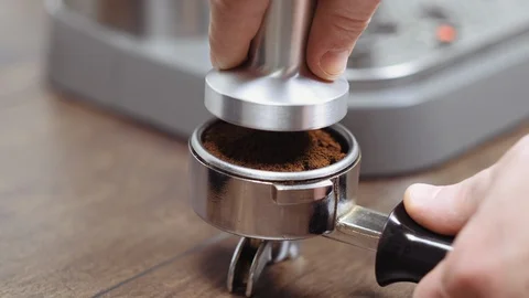Hand tamping coffee, using filter holder and machine. Making coffee process. Stock Footage 112681708