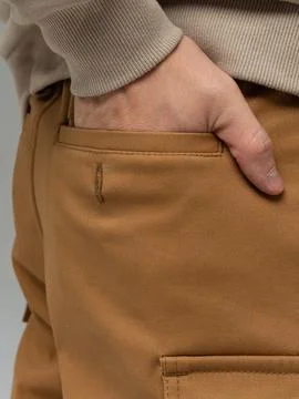 Hand in tan pants front pocket Stock Photos