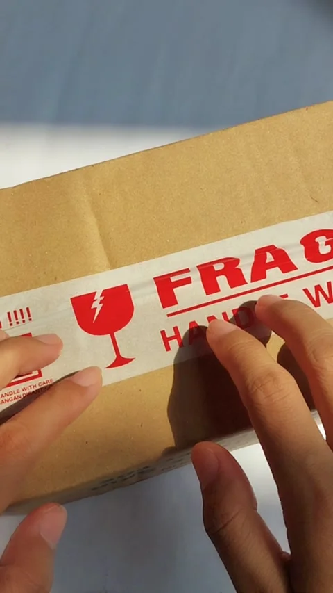 Hand tapping on a cardboard package with finger. Inspecting or checking the.. Stock Footage 330749285