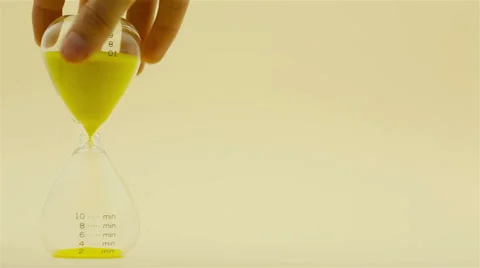 Hand tapping clogged sandglass Stock Footage 32454308