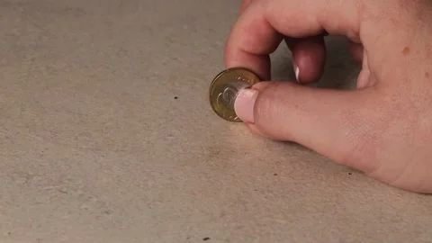 Hand tapping coin on table surface, money sound reflects focus and control,.. Stock Footage 320736233